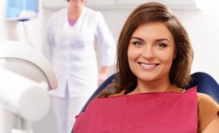 Woman sitting in treatment chair at dentist office in Flowery Branch GA