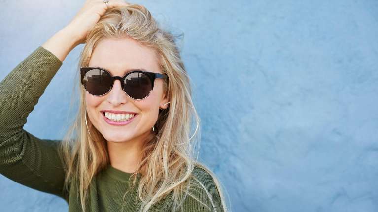 An image of a woman wearing sunglasses