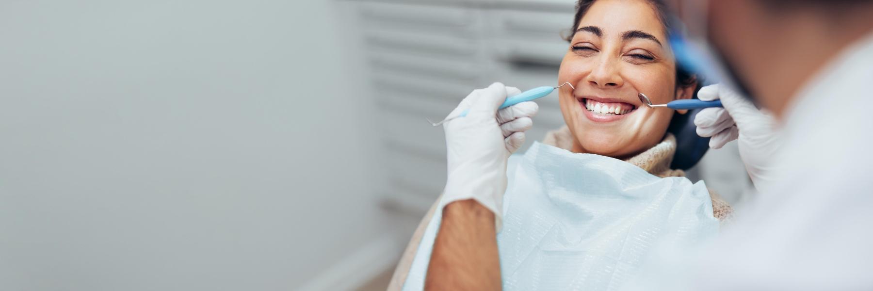 Woman smiling at dentist in Flowery Branch GA