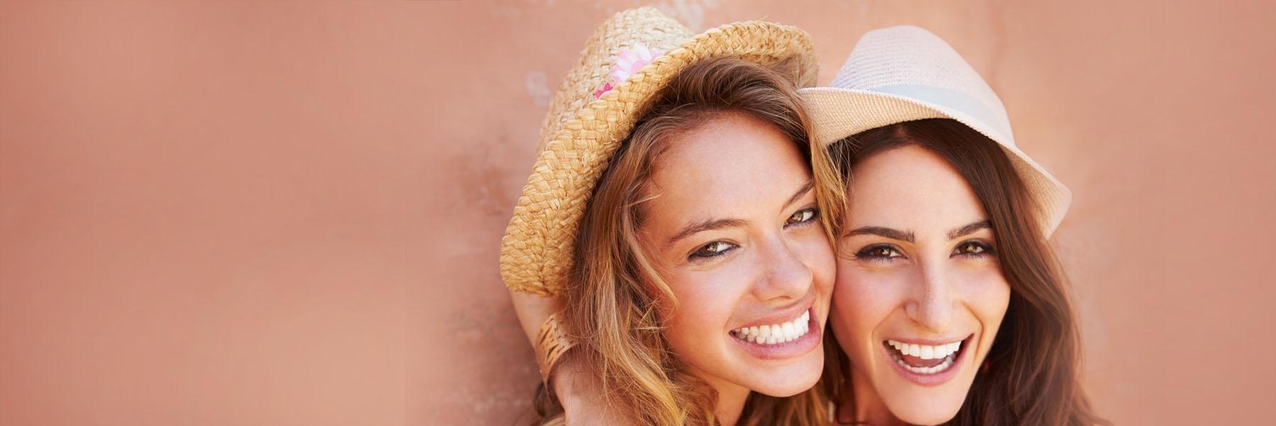 Two women with hats smiling l 30566 Dentist